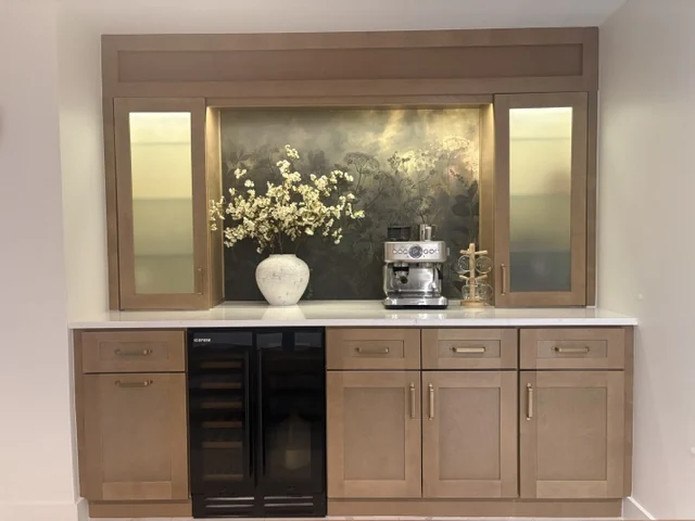 Wood cabinetry framing a coffee bar with a countertop and beverage refrigerator